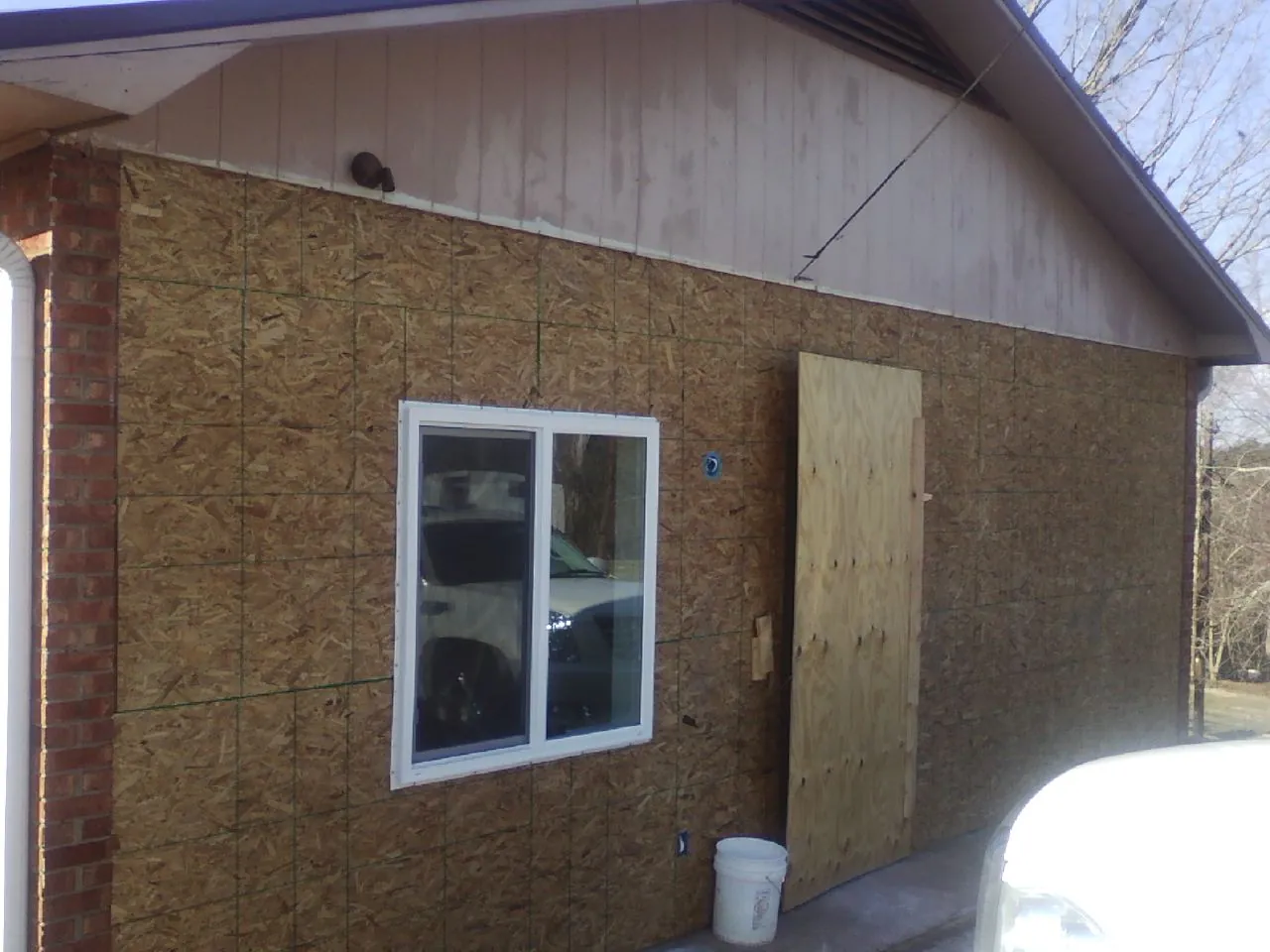 OSB sheathing on a garage addition wall before siding in Hartford